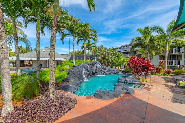 view of swimming pool featuring pool water feature