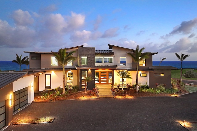 view of front of home featuring a water view and a garage