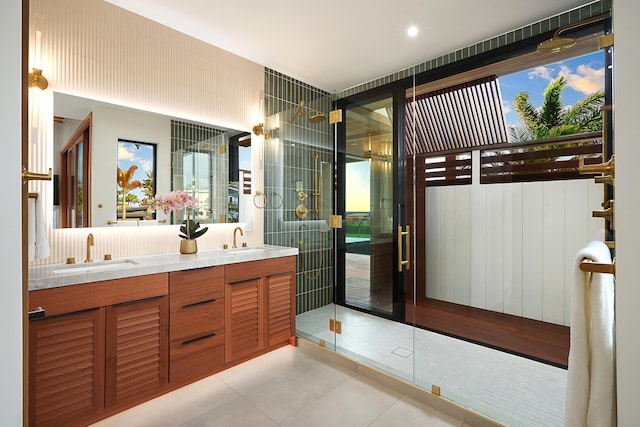 bathroom featuring tile patterned flooring, vanity, and a shower with shower door