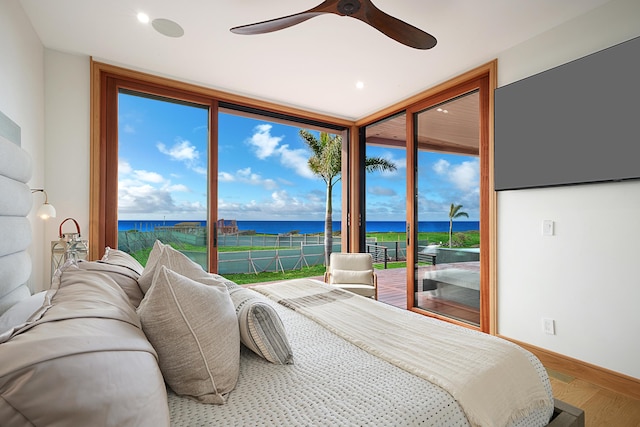 bedroom featuring ceiling fan, access to exterior, a wall of windows, and wood-type flooring