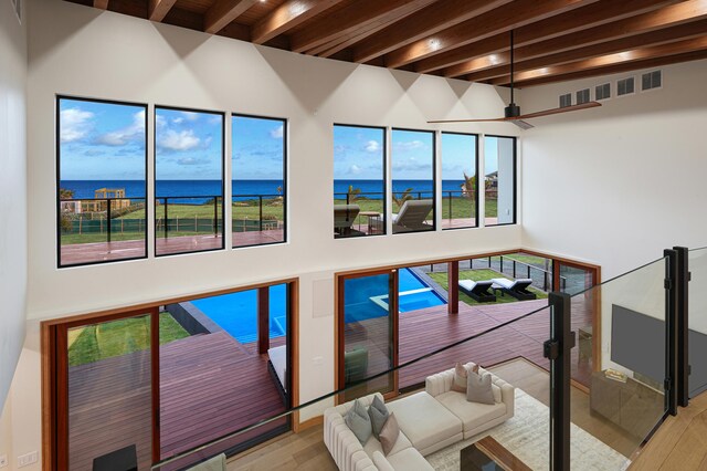 interior space with wood-type flooring and a water view