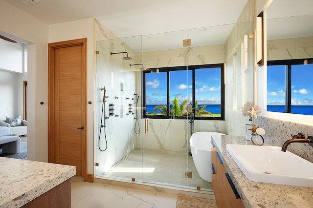 bathroom featuring vanity, a water view, and a shower with door