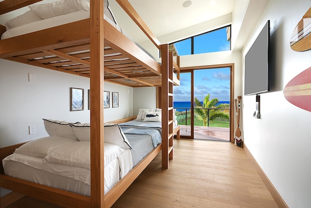 bedroom with access to exterior, light wood-type flooring, and vaulted ceiling