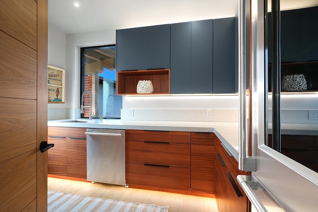 kitchen with black fridge, sink, and light hardwood / wood-style floors