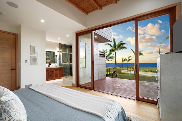 bedroom featuring ensuite bathroom, sink, vaulted ceiling with beams, access to exterior, and wood ceiling