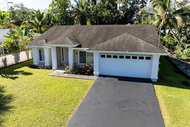 ranch-style house featuring a garage and a front yard