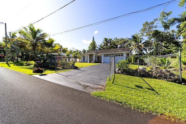 ranch-style house with a garage and a front lawn