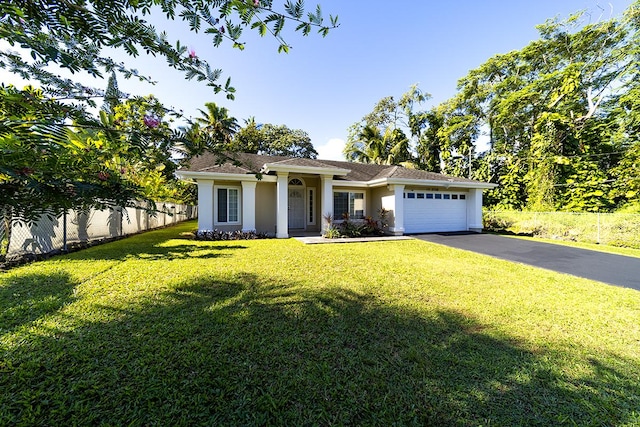 view of front of property featuring a garage and a front yard