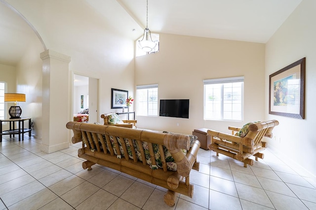 living room with light tile patterned flooring, high vaulted ceiling, and beamed ceiling