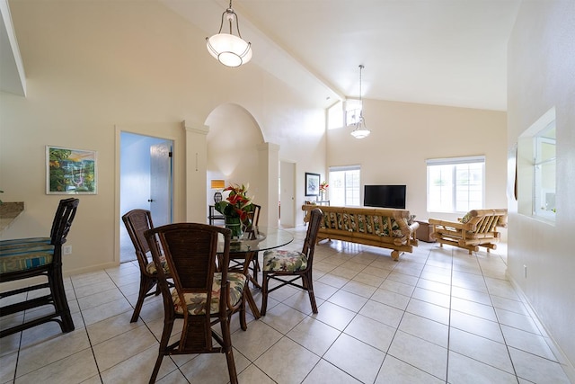 tiled dining area with high vaulted ceiling