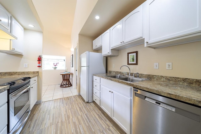 kitchen with white cabinetry, sink, and stainless steel appliances