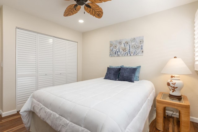 bedroom with ceiling fan, a closet, and dark wood-type flooring