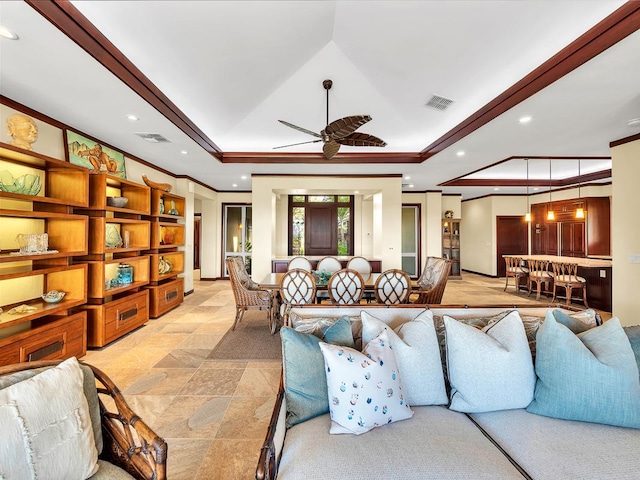 living room featuring ceiling fan and crown molding