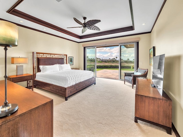 carpeted bedroom with ceiling fan, access to exterior, crown molding, and a raised ceiling