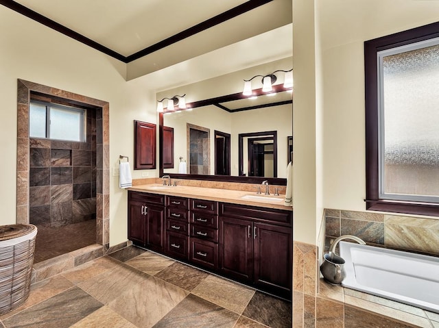 bathroom with plus walk in shower, ornamental molding, and vanity