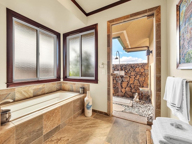 bathroom featuring tiled bath and crown molding