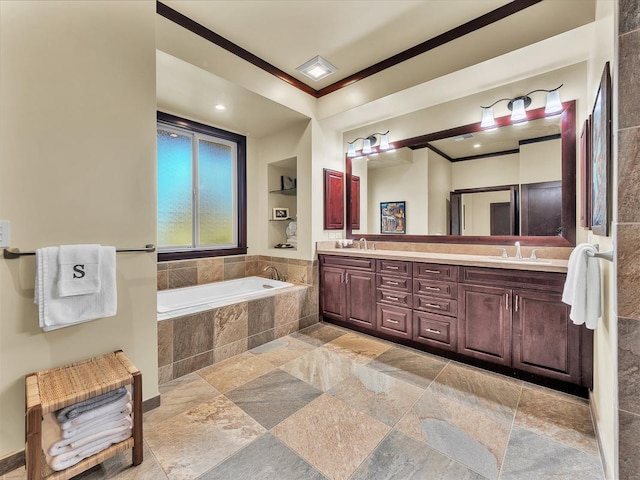 bathroom featuring tiled bath, ornamental molding, and vanity