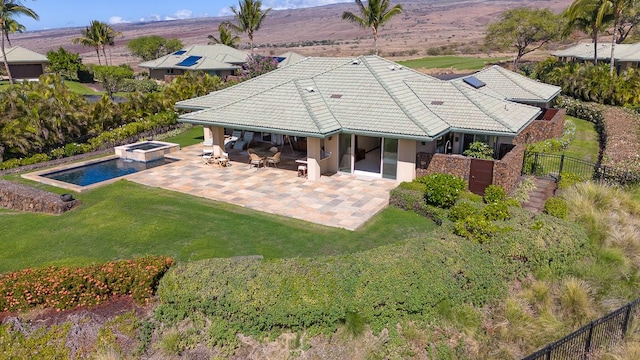 rear view of property with a patio area and a lawn