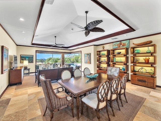 dining area with ceiling fan, crown molding, and a raised ceiling