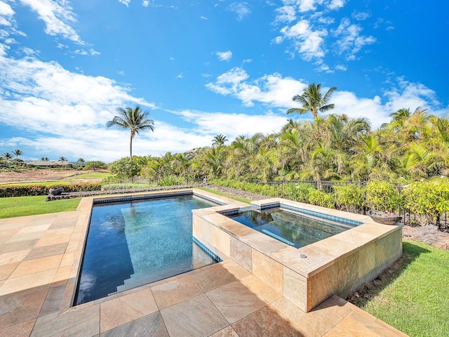 view of swimming pool with an in ground hot tub