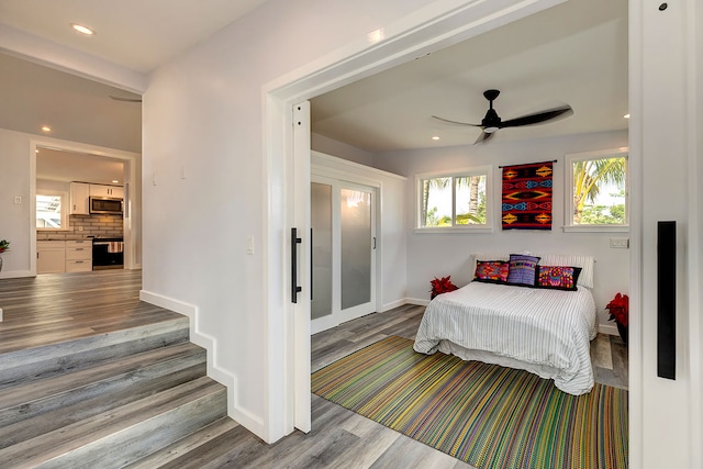 bedroom with ceiling fan and light hardwood / wood-style flooring