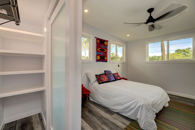 bedroom featuring ceiling fan, wood-type flooring, and lofted ceiling