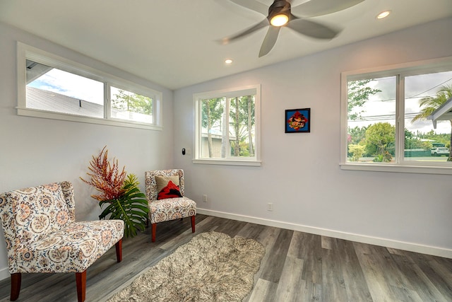 living area with hardwood / wood-style flooring, ceiling fan, and lofted ceiling