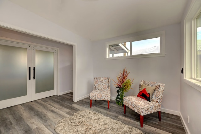 living area featuring wood-type flooring and french doors