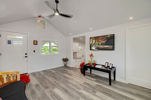 entrance foyer featuring light hardwood / wood-style flooring, ceiling fan, and lofted ceiling