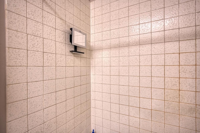 bathroom with a tile shower