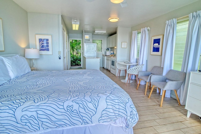 bedroom with ceiling fan and light hardwood / wood-style flooring