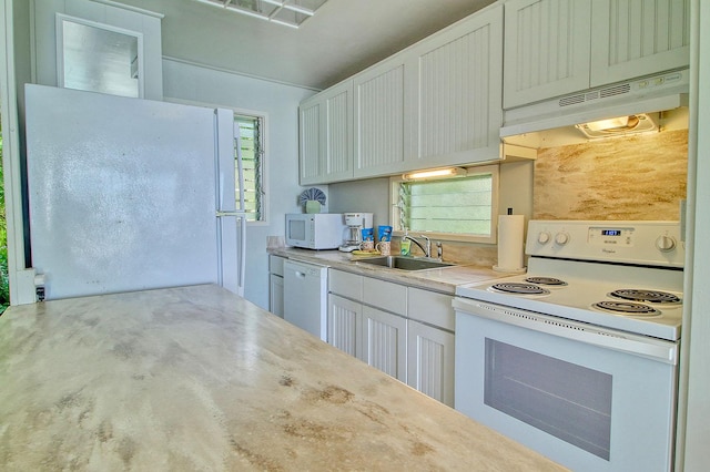 kitchen with white cabinets, white appliances, and sink