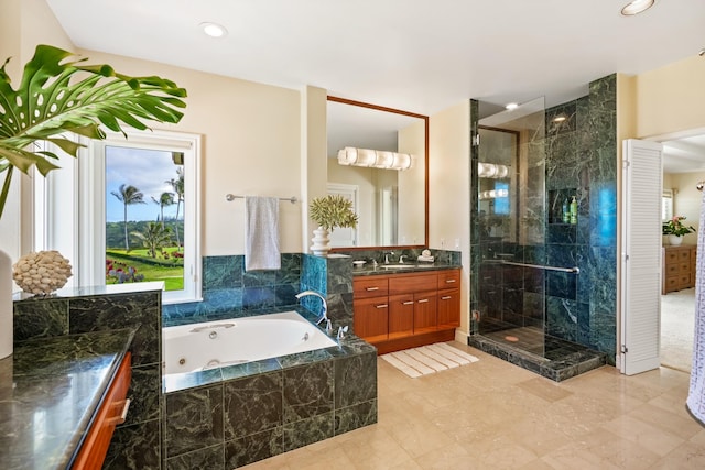 bathroom featuring shower with separate bathtub and vanity