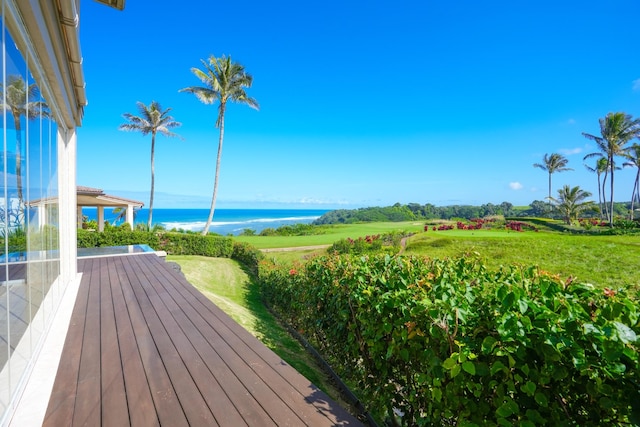 wooden deck featuring a water view and a yard