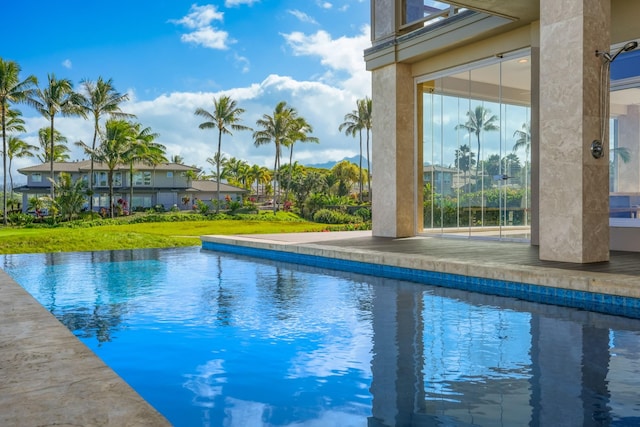 view of pool with a lawn