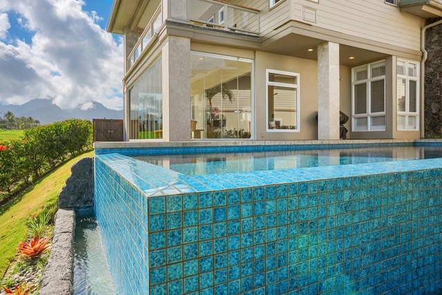 view of swimming pool with a mountain view