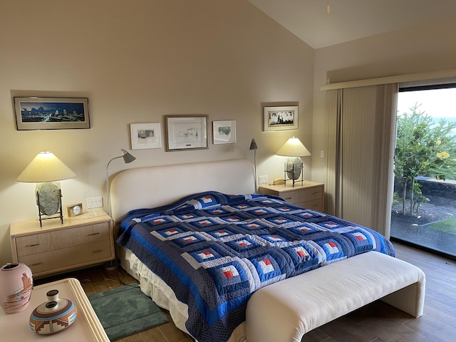 bedroom with lofted ceiling, dark hardwood / wood-style flooring, and access to outside