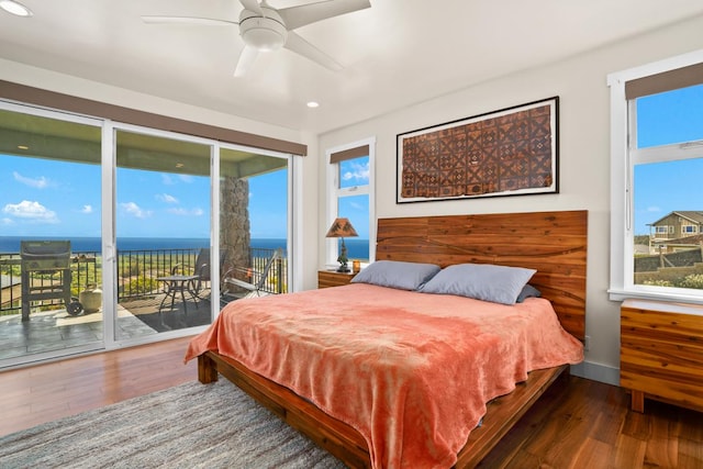 bedroom featuring access to exterior, ceiling fan, a water view, and wood-type flooring