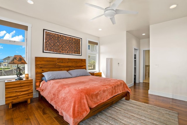 bedroom with dark hardwood / wood-style floors and ceiling fan