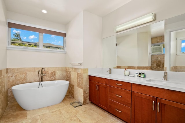 bathroom featuring an AC wall unit, a bathing tub, vanity, and tile walls