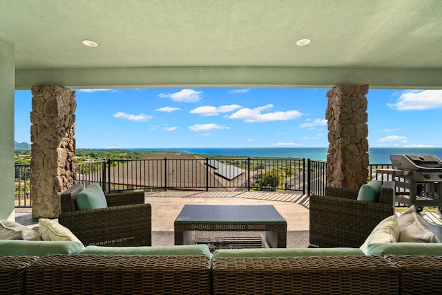 view of patio / terrace with outdoor lounge area, a water view, and a grill