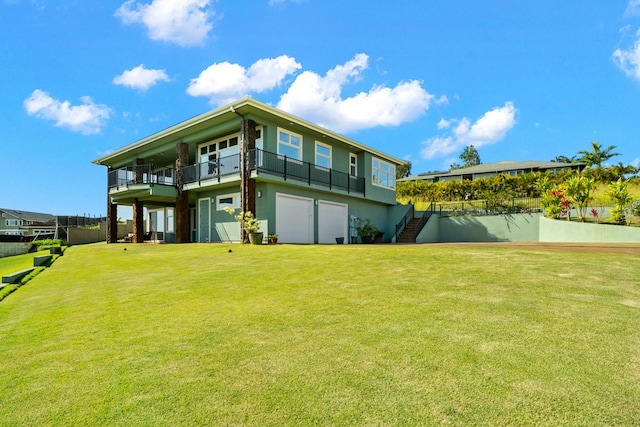 rear view of house with a garage and a lawn