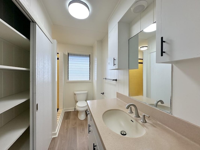 bathroom featuring hardwood / wood-style floors, vanity, and toilet