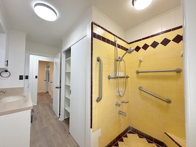 bathroom featuring vanity, wood-type flooring, and walk in shower