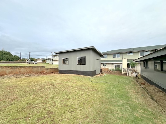 back of house with a lawn