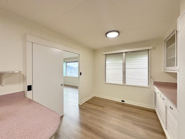 unfurnished dining area with light wood-type flooring