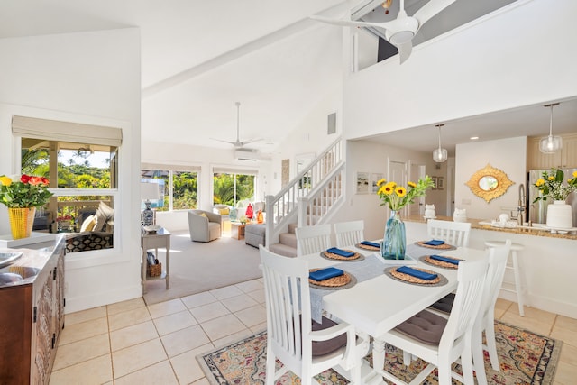 dining room with ceiling fan, a wall mounted air conditioner, high vaulted ceiling, and light tile patterned floors