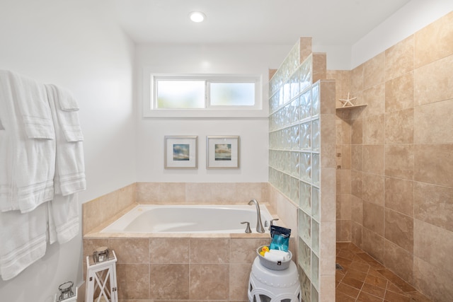 bathroom featuring shower with separate bathtub