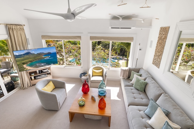 sunroom featuring a wall unit AC, ceiling fan, and a healthy amount of sunlight