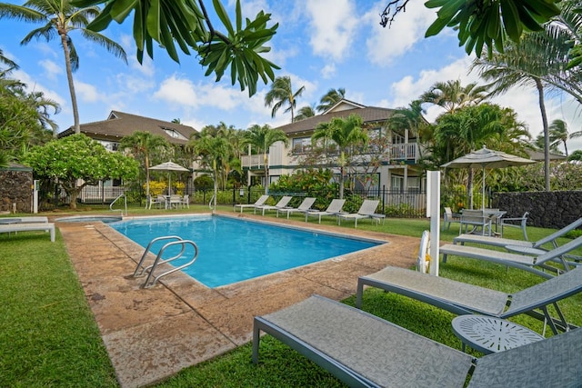 view of pool with a yard